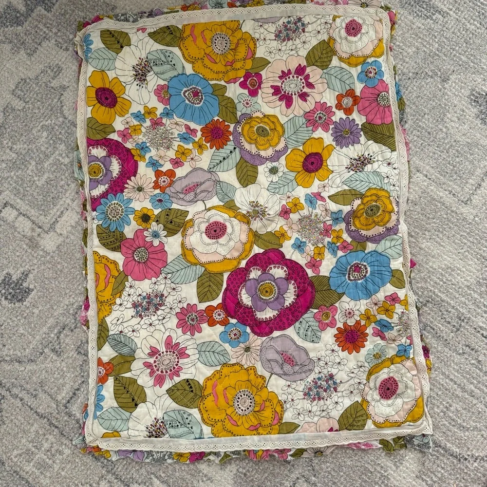 Cynthia Rowley quilted pillow sham with a multicolored boho floral pattern.